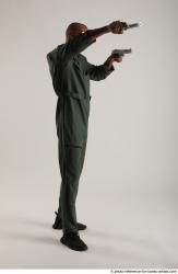 ERIC STANDING POSE WITH GUNS